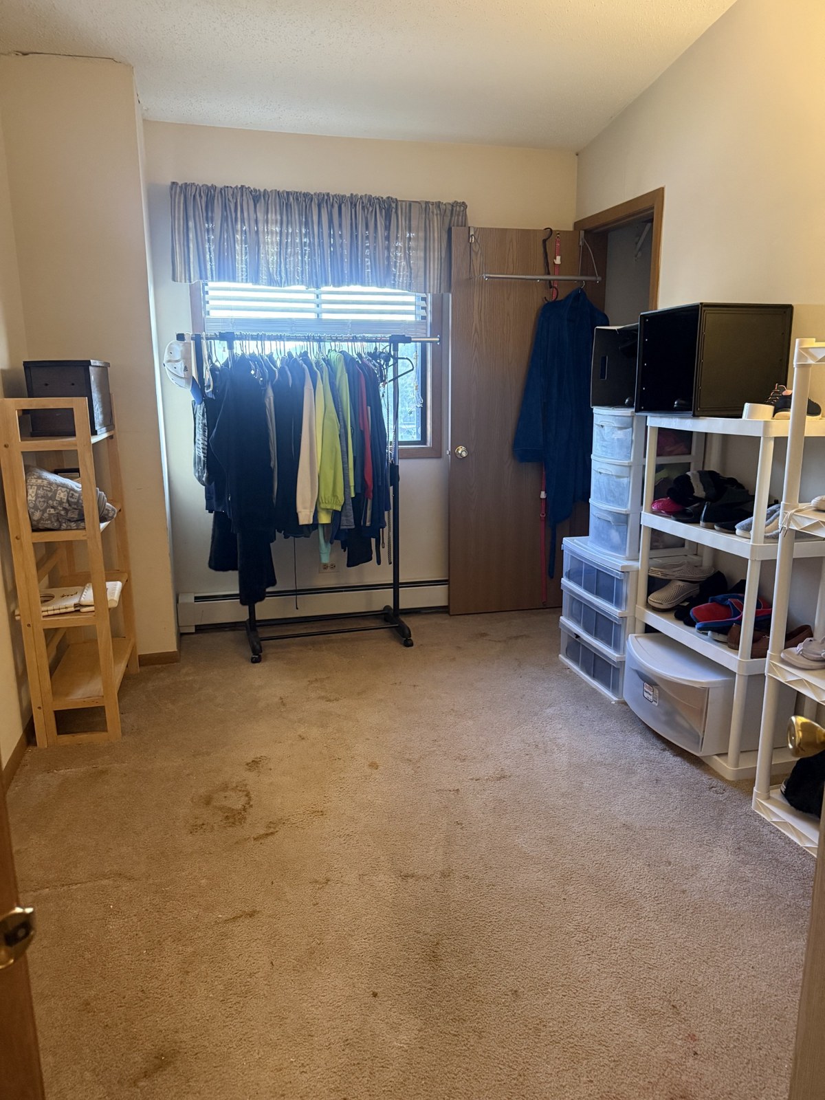 Bedroom with open floor space after decluttering and organizing