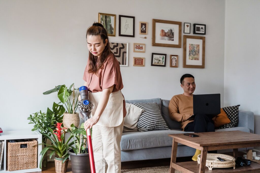 Woman vacuuming a bright modern living room