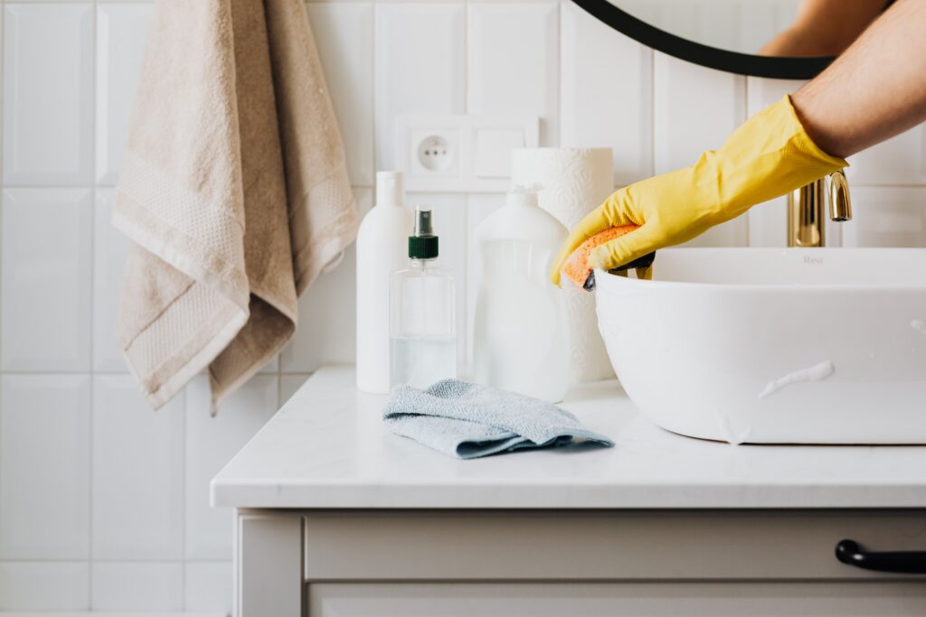 Cleaning a bathroom sink as part of a Plainfield IL house cleaning routine