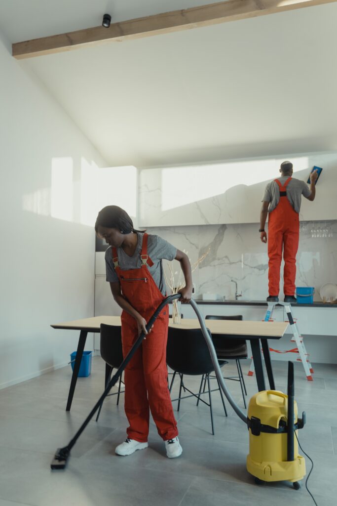 Professional cleaners performing detailed house cleaning in a modern home