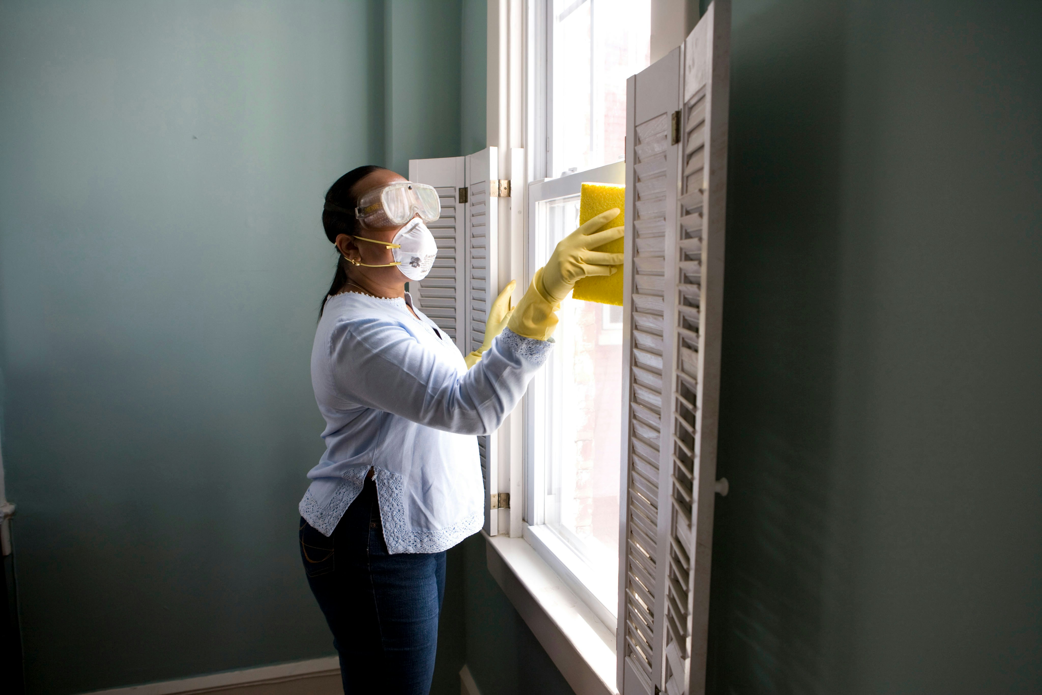 Professional cleaner wiping household surfaces during a detailed home cleaning